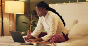 Woman researching how pregnancy tests work on her laptop.