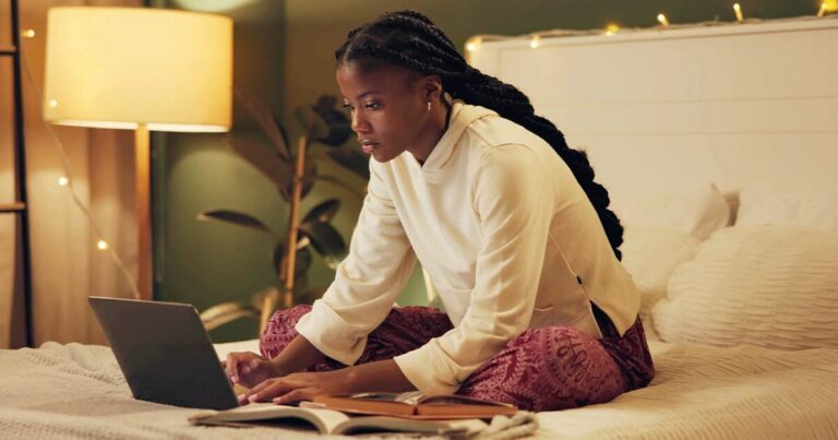 Woman researching how pregnancy tests work on her laptop.